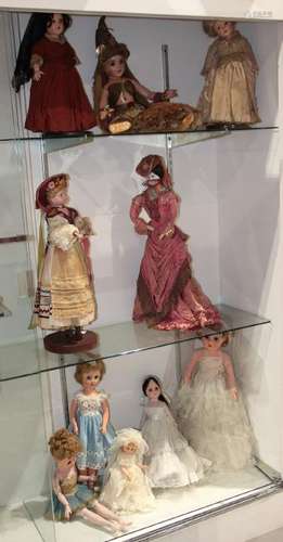 Three shelves of composition and porcelain dolls