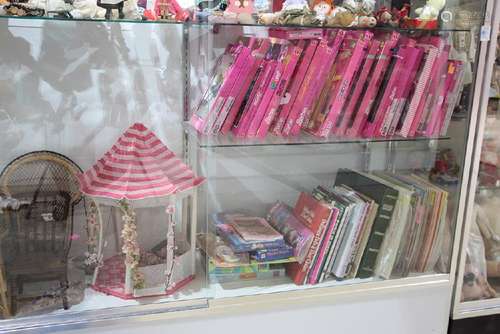 Two shelves of mostly Barbie accesories