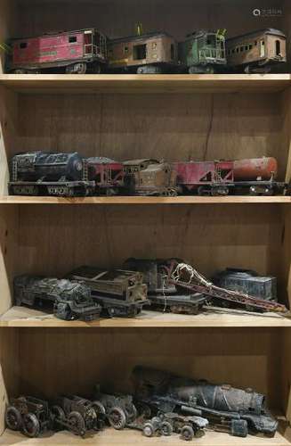 Four shelves of mostly Lionel train cars, such as a no