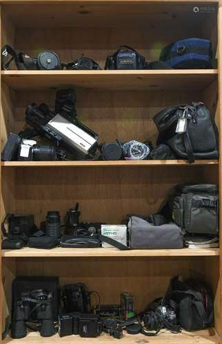 Four shelves of cameras including Canon