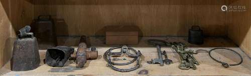 One shelf of antique keys and cow bells