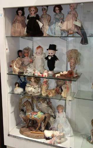 Four shelves of dolls