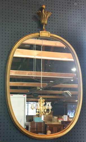 Oval gilt mirror, surmounted with a palm form finial,