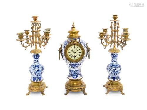 A Delft Pottery Three-Piece Clock Garniture