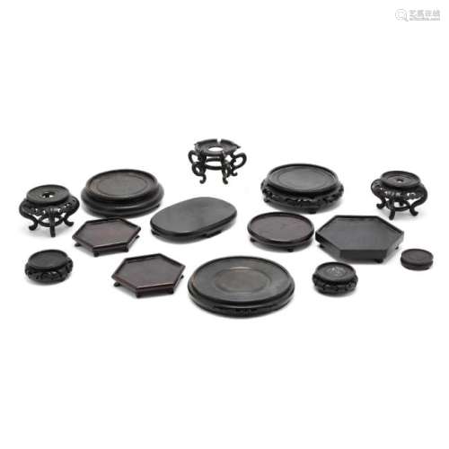 A Group of 14 Assorted Black Asian Wooden Stands