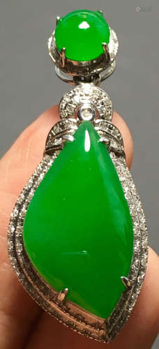 A GREEN JADEITE CARVED PENDANT, TYPE A