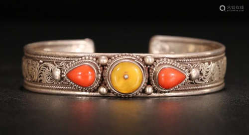 A SILVER CASTED CORAL DECORATED BANGLE