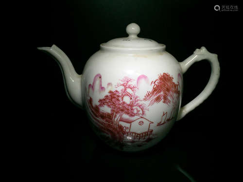 A PORCELAIN TEA POT WITH DARGON SHAPED AHEAD