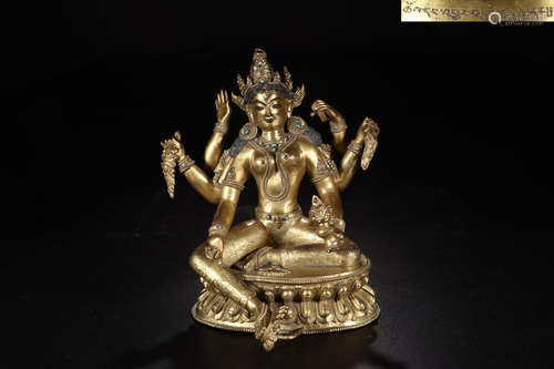 A COPPER GILT SIX-ARM GUANYIN STATUE