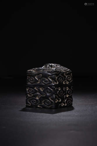 A DARK STONE BOX CARVED IN DRAGON