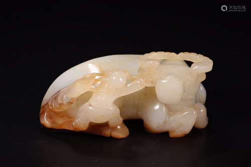 A HETIAN JADE 'TONGZIMUNIU' FIGURE