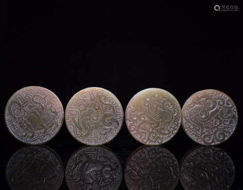 FOUR HETIAN JADE PENDANTS OF BEAST CARVING