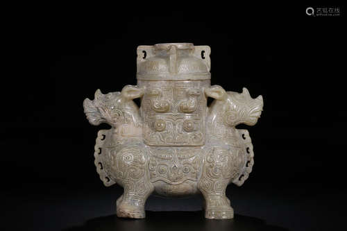 AN ANCIENT JADE POT IN RHINOCEROS DESIGN