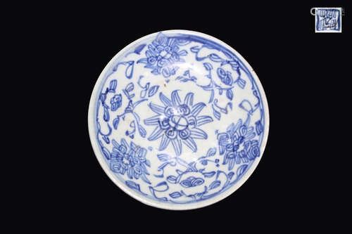 A BLUE AND WHITE PLATE WITH FLOWER PAINTED