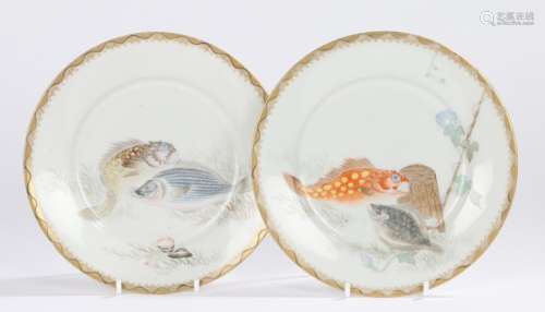 Pair of Japanese porcelain plates, decorated with fish swimming and seaweed shell surround, eight