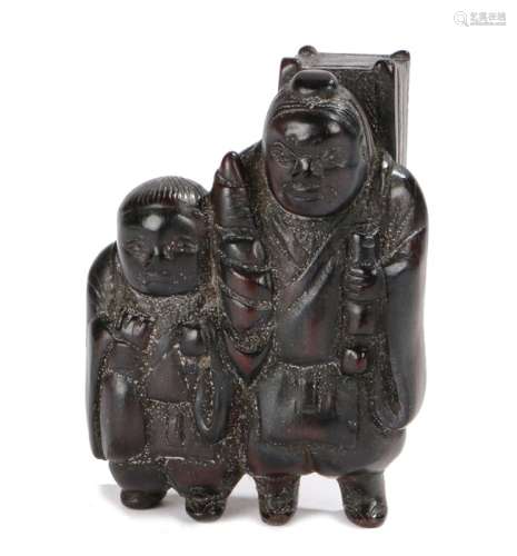 Japanese Meiji period netsuke, the wood netsuke depicting two standing figures with baskets to their