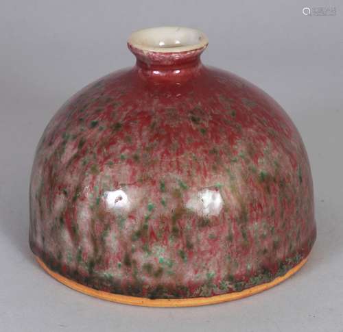 A CHINESE PEACH BLOOM PORCELAIN BEEHIVE WATER POT, the red streaked glaze with green inclusions,