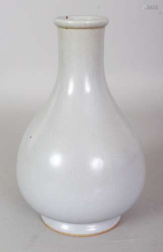 A CHINESE JUN STYLE PORCELAIN BOTTLE VASE, applied with a pale blue-green glaze, 20.3cm high.