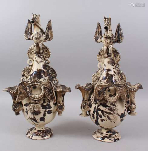 A PAIR OF 17TH CENTURY TURKISH CANAKKALE POTTERY EWERS, the handle formed as a winged horse with