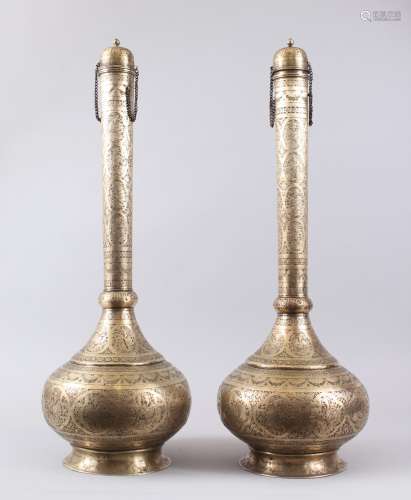 A GOOD PAIR OF 19TH CENTURY PERSIAN QAJAR HAND CHASED BRASS TALL BOTTLE VASES