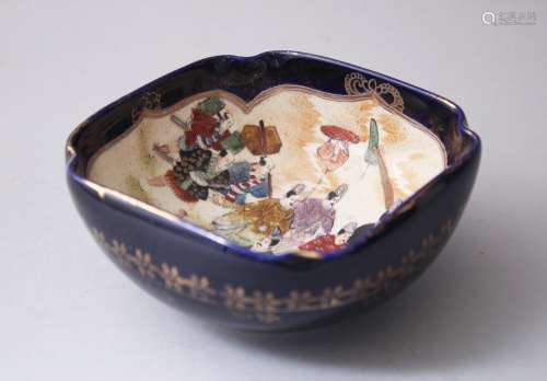 A JAPANESE MEIJI PERIOD SATSUMA BOWL, the blue ground with decorated scenes of figures in parade