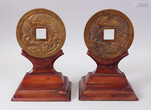 A PAIR OF CHINESE 20TH CENTURY BRONZE BI - DISKS & HARDWOOD STANDS, both with carved dragin and