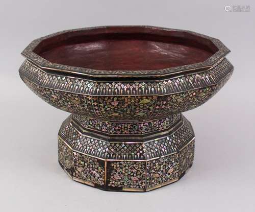 A LARGE 19TH CENTURY THAI MOTHER OF PEARL INLAID LACQUERED TWELVE SIDED PEDESTAL BOWL, 36cm diameter