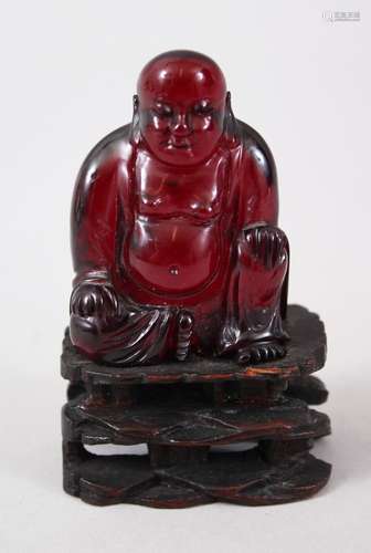 A GOOD 19TH CENTURY CHINESE CHERRY AMBER CARVED FIGURE OF BUDDHA, seated upon a carved and pierced