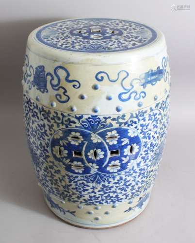 A GOOD CHINESE BLUE AND WHITE PORCELAIN GARDEN BARREL SEAT, decorated with implements and ribbon,