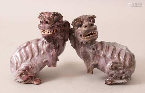 A PAIR OF EARLY 20TH CENTURY CHINESE PURPLE GLAZED SHIWAN STYLE POTTERY LION / FOO DOGS, both