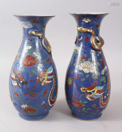 A PAIR OF 19TH CENTURY CHINESE BLUE GROUND FAMILLE ROSE PORCELAIN VASES, the necks of the vases with