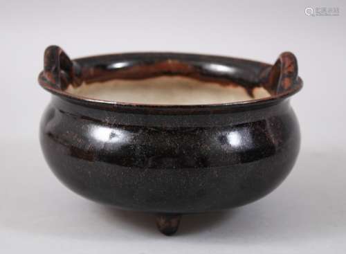 A 19TH CENTURY CHINESE BLACK GLAZED WU JIN YOU TRIPLE FOOT POTTERY TRIPOD CENSER, stood upon three