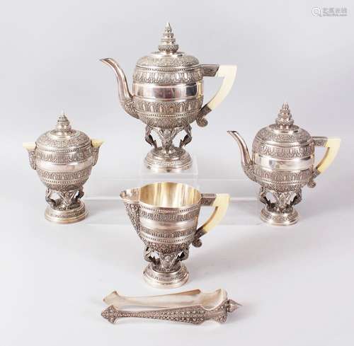 A SUPERB BURMESE SILVER FIVE PIECE TEA SET, with all-over decoration and ivory handles, comprising