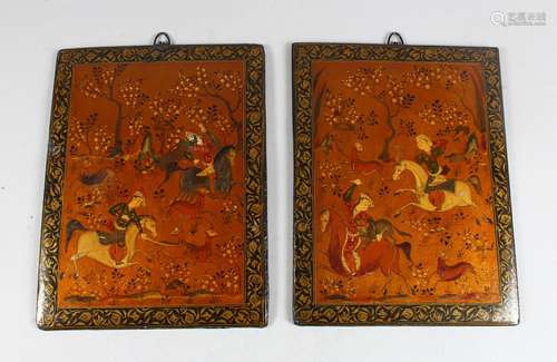 A PAIR OF 19TH CENTURY QAJAR HAND PAINTED BOOK COVERS, deer hunting, 26cm x 19cm.