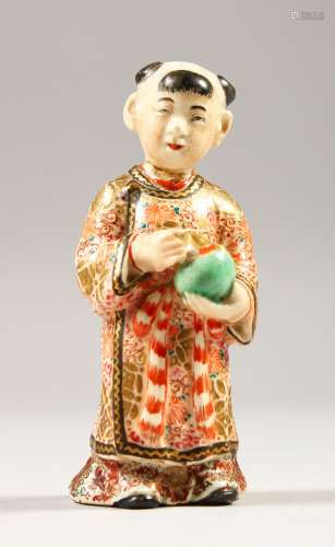 A JAPANESE SATSUMA MODEL OF A BOY, stood holding a jar, wearing traditional attire, signed to the