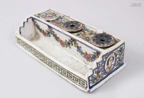 A 19TH CENTURY PERSIAN GLAZED POTTERY INKSTAND with three ink bottles and pen holder, 20cm long.