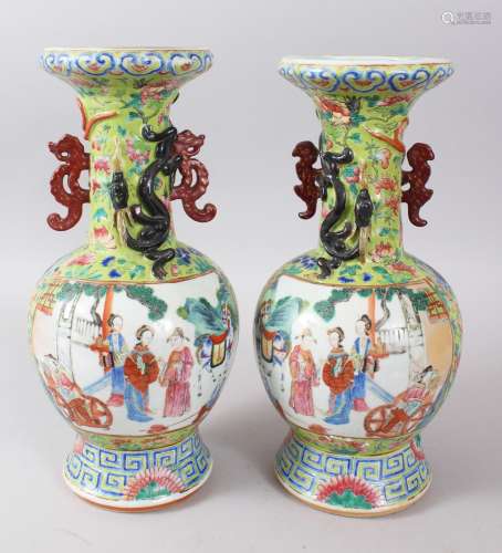 A PAIR OF 19TH CENTURY CHINESE FAMILLE ROSE TWIN HANDLE PORCELAIN VASES, the panels depicting scenes