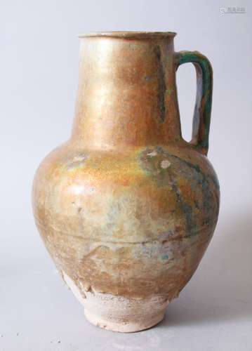 A 12TH-13TH CENTURY PERSIAN KASHAN OR SYRIAN GOLD SPLASH POTTERY EWER, 31cm high.