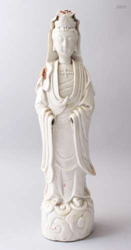 A 18TH / 19TH CENTURY CHINESE BLANC DE CHINE FIGURE OF GUANYIN, stood upon a stylized wave base in