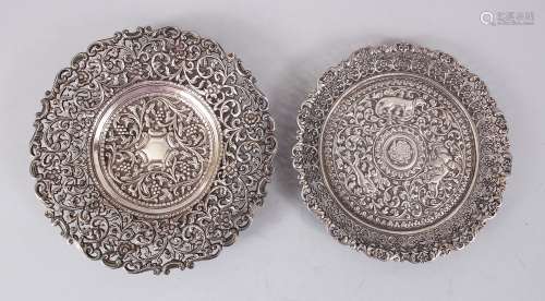 TWO 19TH CENTURY INDIAN FINELY CHASED SILVER CIRCULAR DISHES, 16cm diameter.