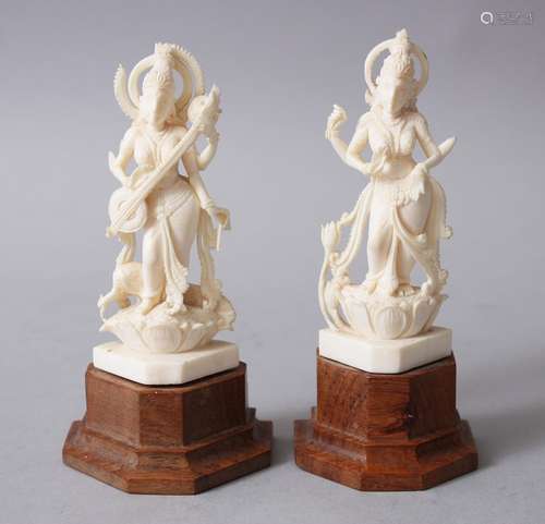 A SMALL PAIR OF 19TH CENTURY INDIAN CARVED IVORY DEITIES, both pinned on wooden bases. 12cm high x