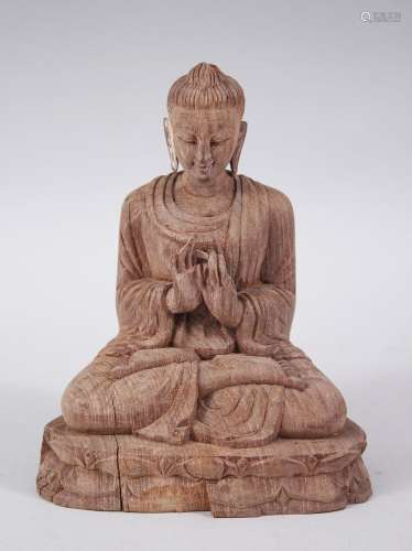 A 20TH CENTURY CHINESE / THAI HARDWOOD CARVED BUDDHA, in a seated meditating position, carved from