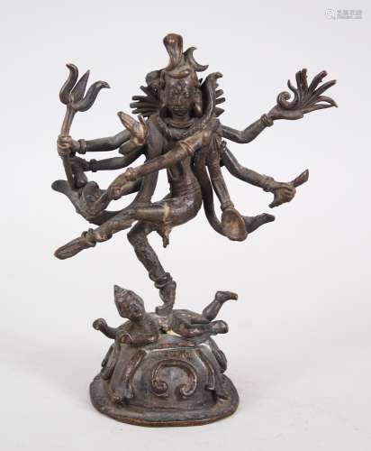 A 19TH / 20TH CENTURY NEPALESE BRONZE DEITY / BUDDHA, stood upon another figure, with eight arms