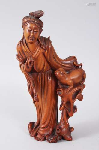 A 19TH CENTURY CHINESE CARVED WOODEN FIGURE OF GUANYIN, guanyin is shown holding a pouch in her