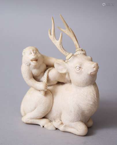 A FINE QUALITY JAPANESE MEIJI PERIOD CARVED IVORY MONKEY AND STAG OKIMONO, the stand in a seated