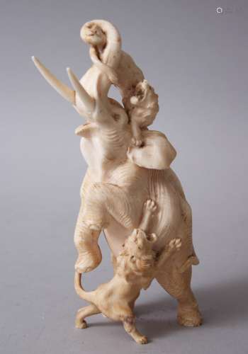 A GOOD JAPANESE MEIJI PERIOD CARVED IVORY OKIMONO - ELEPHANT AND LION GROUP, the elephant in an