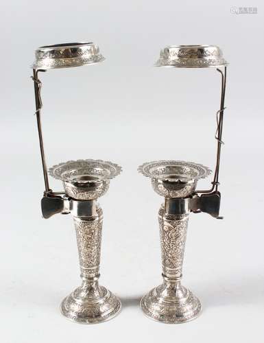 A VERY FINE PAIR OF PERSIAN QAJAR WHITE METAL CANDLESTICKS, 19cm high with holders.