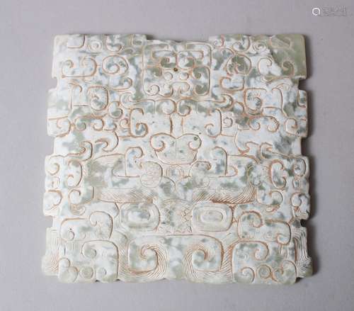 A 19TH / 20TH CENTURY CHINESE CARVED SNOWFLAKE JADE PLAQUE / PENDANT, carved with archaic style