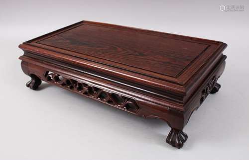 A CHINESE 19TH / 20TH CENTURY HUANGHUALI HARDWOOD LOW STAND, the frieze carved and pierced and stood