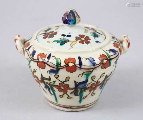 A 19TH CENTURY TURKISH KUTAHYA POTTERY LIDDED JAR with polychrome decoration depicting floral